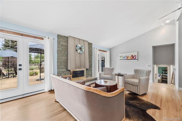 7767 S Depew St, Littleton, CO 80128 - living room featuring wood finished floors, vaulted ceiling, and a fireplace
