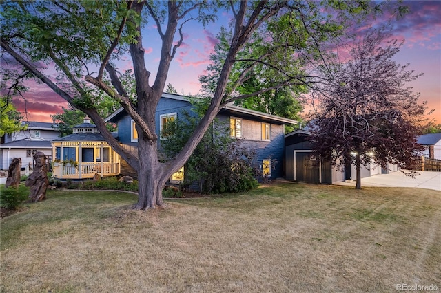 7767 S Depew St, Littleton, CO 80128 - view of front of home with an outbuilding, a yard, and a wooden deck