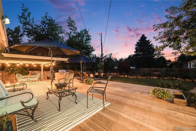 7767 S Depew St, Littleton, CO 80128 - deck featuring outdoor dining space and a fenced backyard