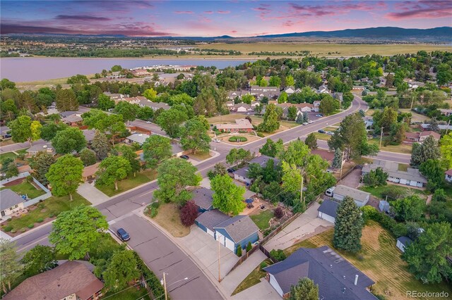 7767 S Depew St, Littleton, CO 80128 - aerial view at dusk of a residential view and a water and mountain view