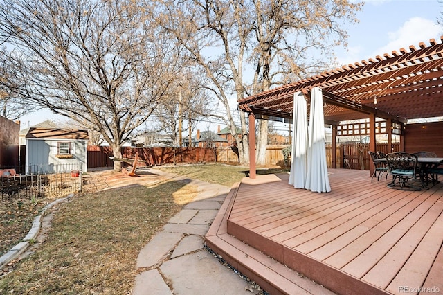 wooden terrace with outdoor dining area, a fenced backyard, an outdoor structure, and a pergola