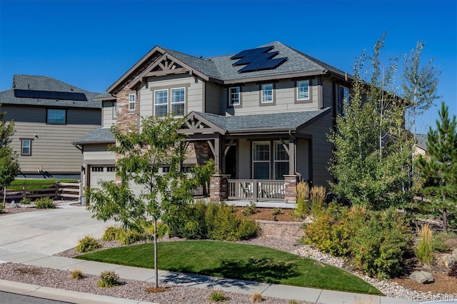 craftsman-style home featuring a porch, solar panels, a front lawn, and a garage