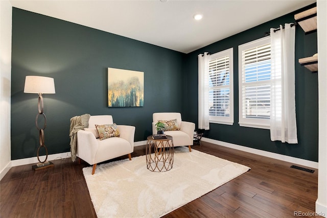 sitting room with dark hardwood / wood-style flooring