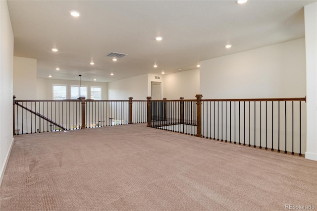 unfurnished room featuring light carpet