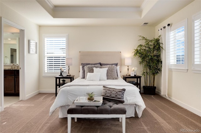 bedroom featuring ensuite bathroom, multiple windows, light carpet, and crown molding