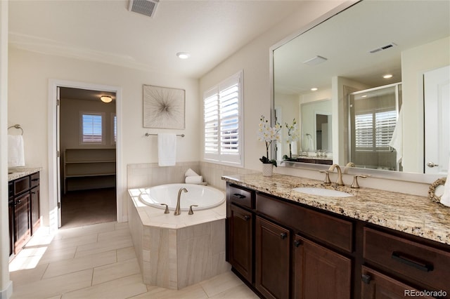 bathroom with shower with separate bathtub, vanity, and tile patterned flooring