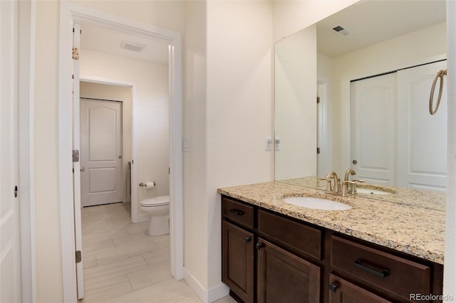 bathroom featuring vanity and toilet