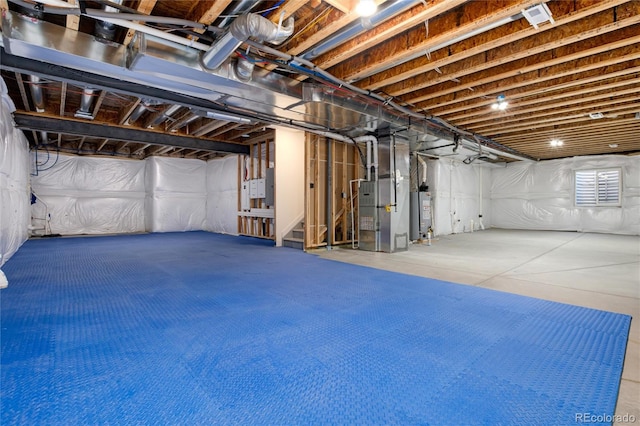 basement featuring water heater and heating unit