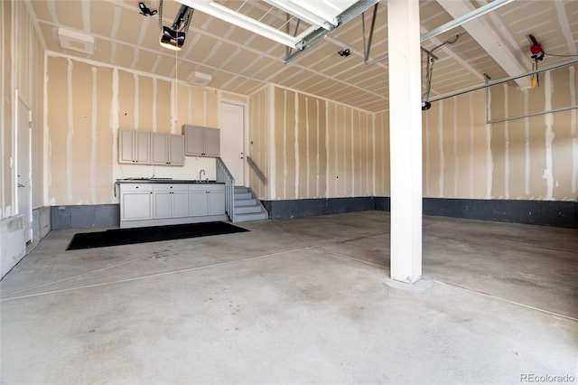 garage featuring a garage door opener and sink