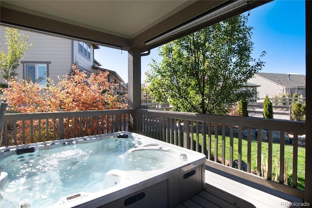 deck featuring an outdoor hot tub