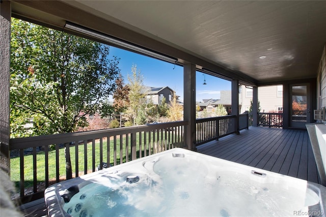 wooden terrace featuring a hot tub