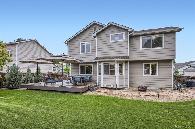1641 Cedarwood Dr, Longmont, CO 80504 - back of property featuring a deck, an outdoor hangout area, and a lawn
