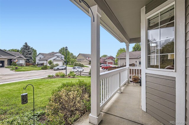 1641 Cedarwood Dr, Longmont, CO 80504 - covered porch featuring a residential view and a yard