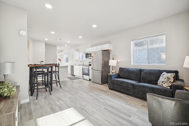 living room featuring light hardwood / wood-style floors and sink