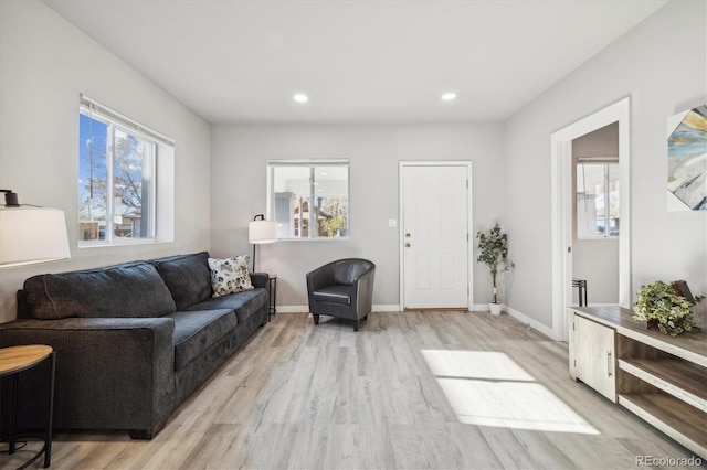 living room with plenty of natural light and light hardwood / wood-style floors