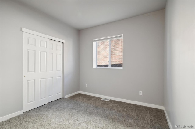 unfurnished bedroom with carpet flooring and a closet