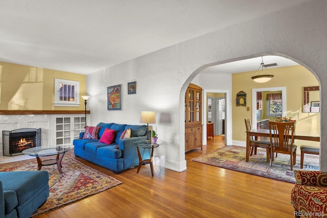 living room with a fireplace and hardwood / wood-style flooring