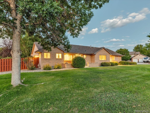 single story home with a front lawn