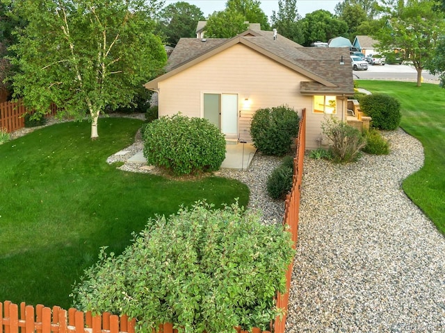 view of property exterior featuring a patio and a yard