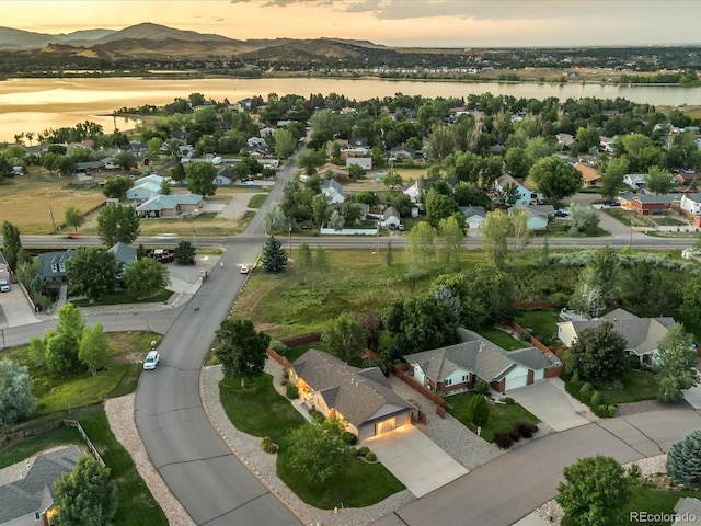 aerial view at dusk with a water and mountain view