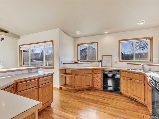 kitchen with black appliances, lofted ceiling, tasteful backsplash, sink, and light hardwood / wood-style flooring