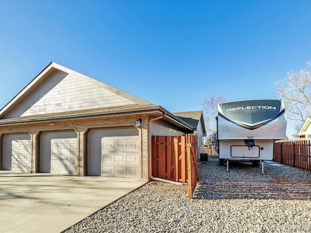 view of property exterior featuring a garage and an outbuilding