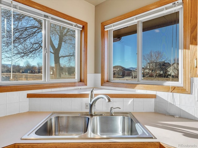 kitchen with sink, a healthy amount of sunlight, and tasteful backsplash