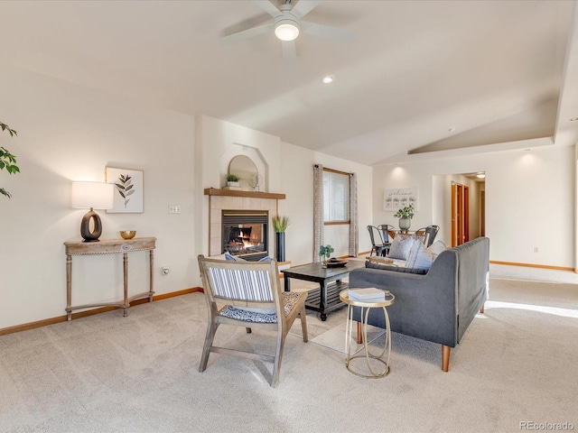 living room with ceiling fan, light colored carpet, a fireplace, and lofted ceiling