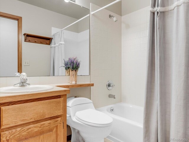 full bathroom featuring toilet, shower / tub combo, and vanity