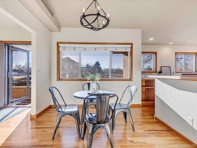 dining room featuring light hardwood / wood-style floors and a notable chandelier