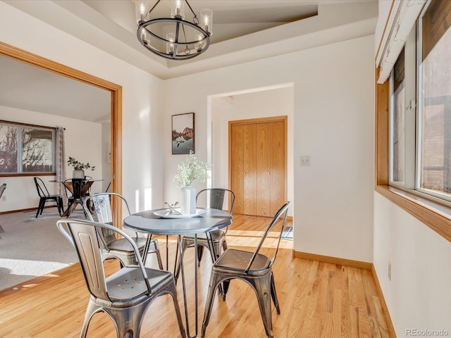 dining room with an inviting chandelier and light hardwood / wood-style flooring