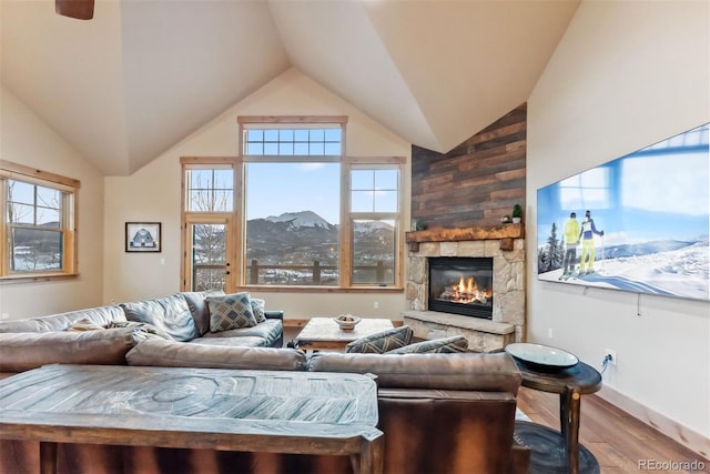 52 Buckskin Ln, Silverthorne, CO 80498 - living area with wood finished floors, a stone fireplace, and high vaulted ceiling