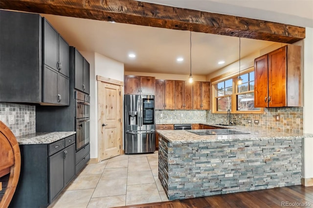 52 Buckskin Ln, Silverthorne, CO 80498 - kitchen with a peninsula, appliances with stainless steel finishes, light stone counters, decorative backsplash, and recessed lighting