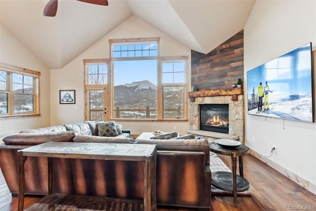 52 Buckskin Ln, Silverthorne, CO 80498 - living room featuring hardwood / wood-style floors, a ceiling fan, a stone fireplace, and high vaulted ceiling