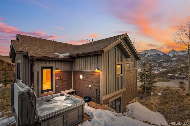 52 Buckskin Ln, Silverthorne, CO 80498 - view of front facade featuring a hot tub, a shingled roof, board and batten siding, and a mountain view