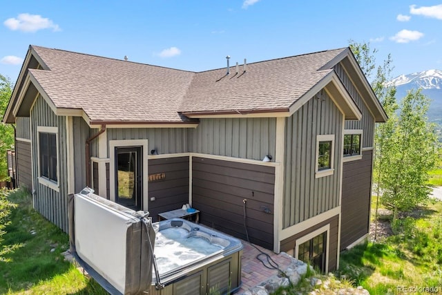 52 Buckskin Ln, Silverthorne, CO 80498 - rear view of property featuring a hot tub, a shingled roof, and a mountain view