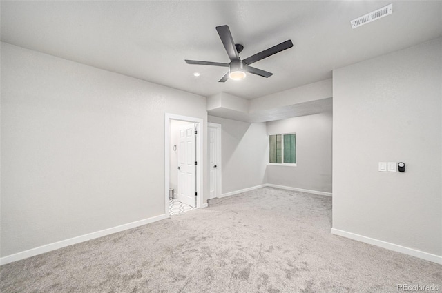 empty room with light colored carpet and ceiling fan