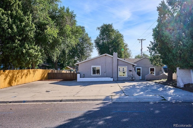view of front of home with fence and driveway