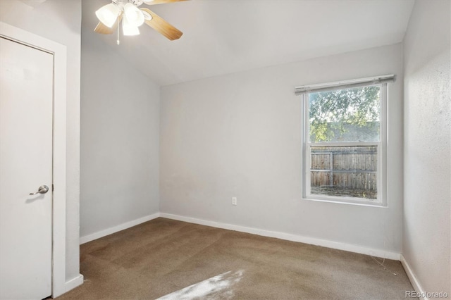 unfurnished room featuring carpet, baseboards, a ceiling fan, and lofted ceiling