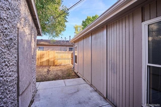 view of side of property with fence and a patio area