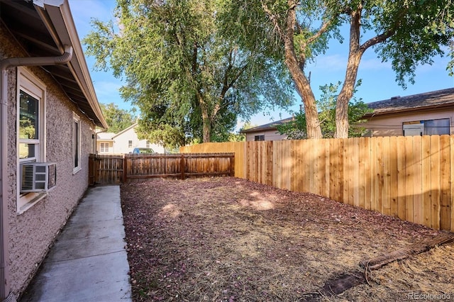 view of yard with cooling unit and a fenced backyard