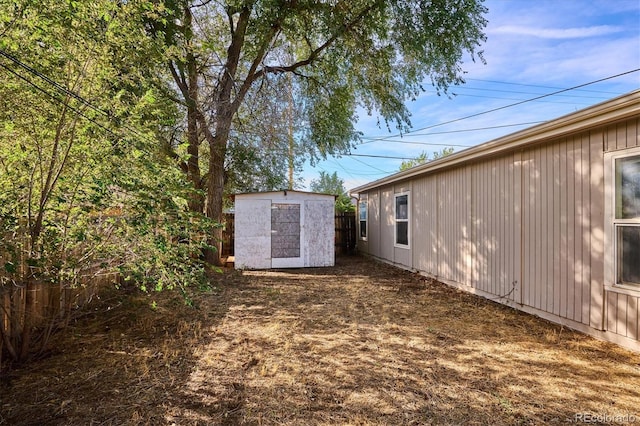 view of yard featuring an outbuilding and a shed
