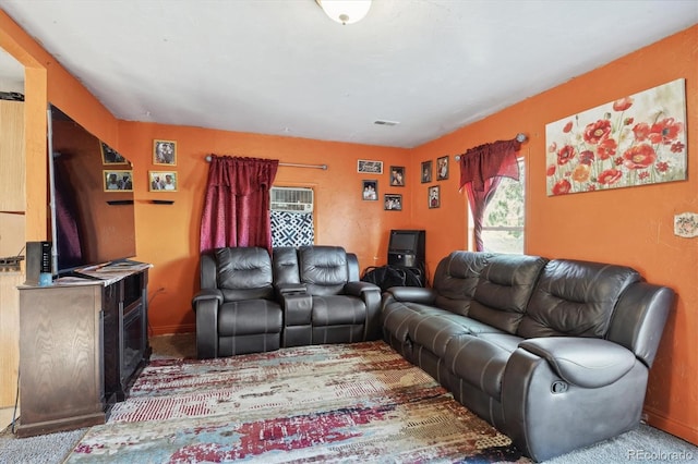 carpeted living room with baseboards