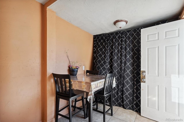 dining space featuring light tile patterned flooring