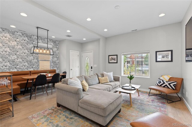 3443 Lawrence St, Denver, CO 80205 - living area featuring recessed lighting, light wood-style floors, and a chandelier