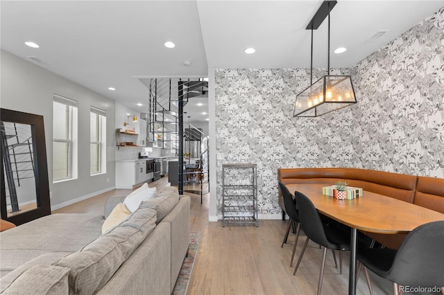 3443 Lawrence St, Denver, CO 80205 - living area featuring recessed lighting, light wood finished floors, and stairs