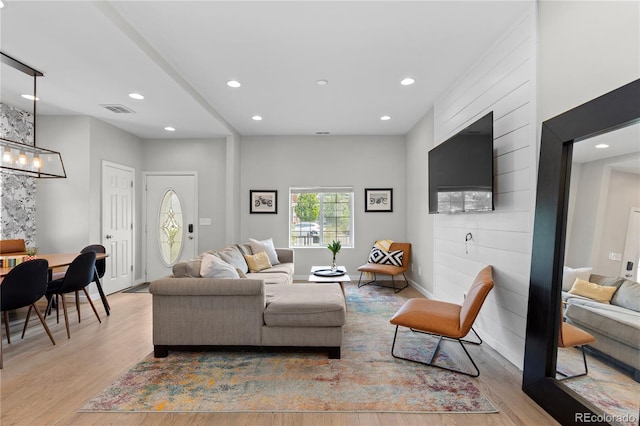 3443 Lawrence St, Denver, CO 80205 - living area with light wood finished floors, recessed lighting, and a chandelier