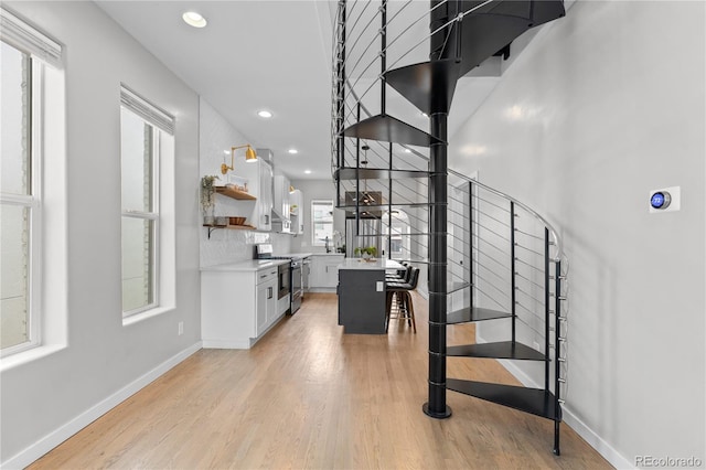 3443 Lawrence St, Denver, CO 80205 - stairway featuring wood finished floors and recessed lighting
