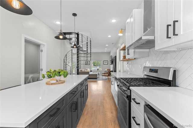 3443 Lawrence St, Denver, CO 80205 - kitchen with appliances with stainless steel finishes, wall chimney range hood, white cabinets, light countertops, and recessed lighting