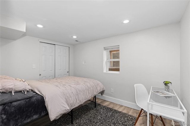 3443 Lawrence St, Denver, CO 80205 - bedroom with light wood-type flooring, a closet, and recessed lighting